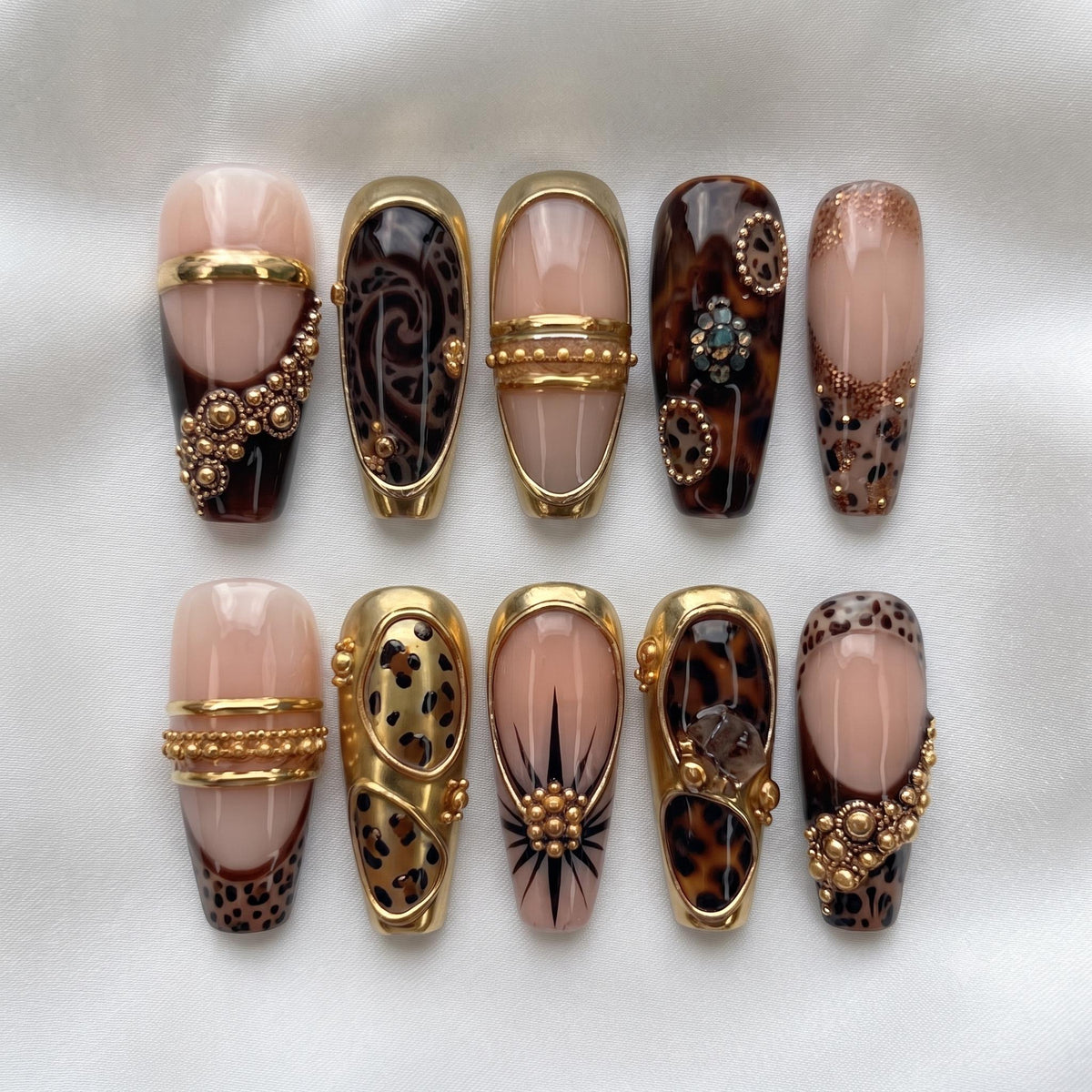 Nude Pink and Tortoiseshell Animal Print Nails with Gold Bands and Jewel Accents