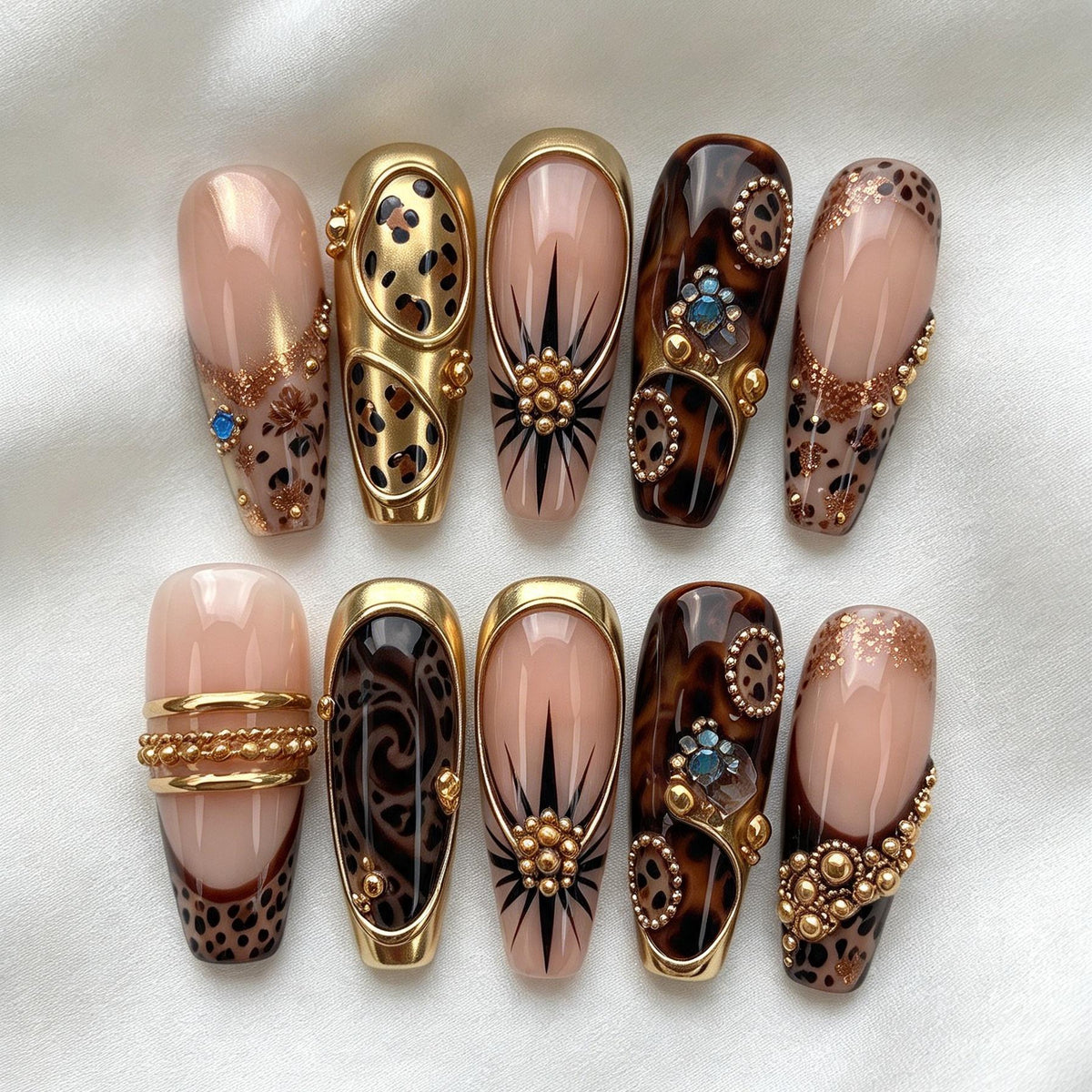 Nude Pink and Tortoiseshell Animal Print Nails with Gold Bands and Jewel Accents