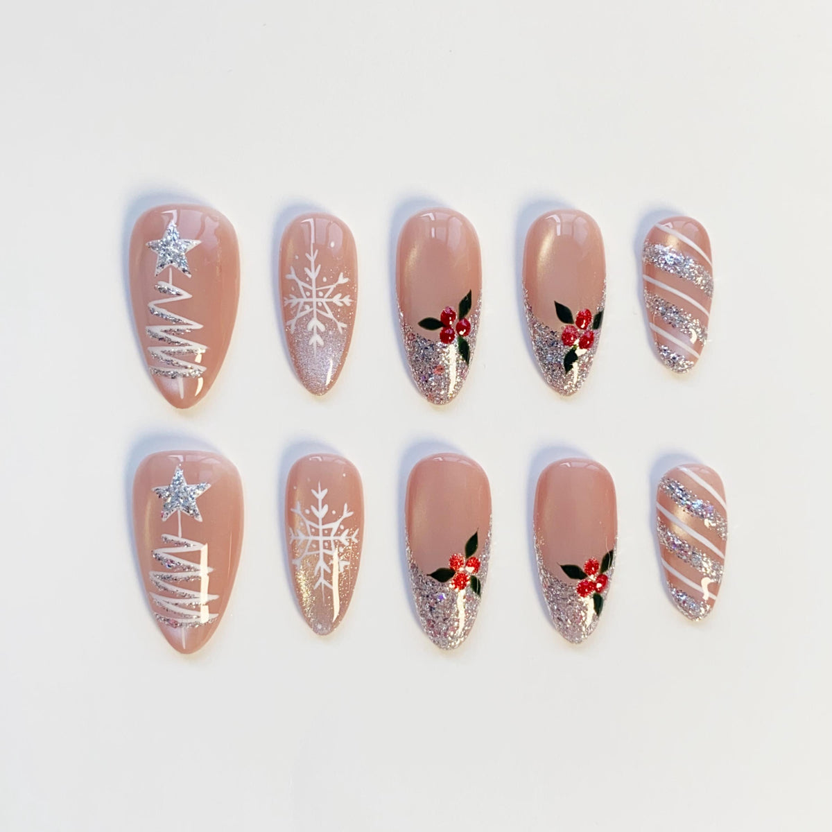 Nude Pink Christmas Nails With Silver Glitter Trees, Snowflakes, and Holly