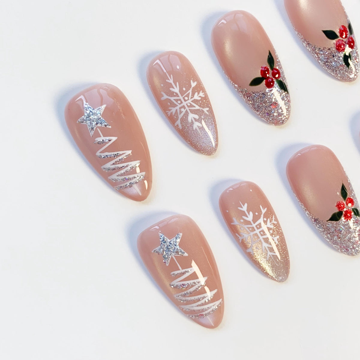 Nude Pink Christmas Nails With Silver Glitter Trees, Snowflakes, and Holly