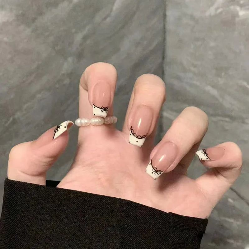 Nude Pink French Tip Nails With Black Bow Details