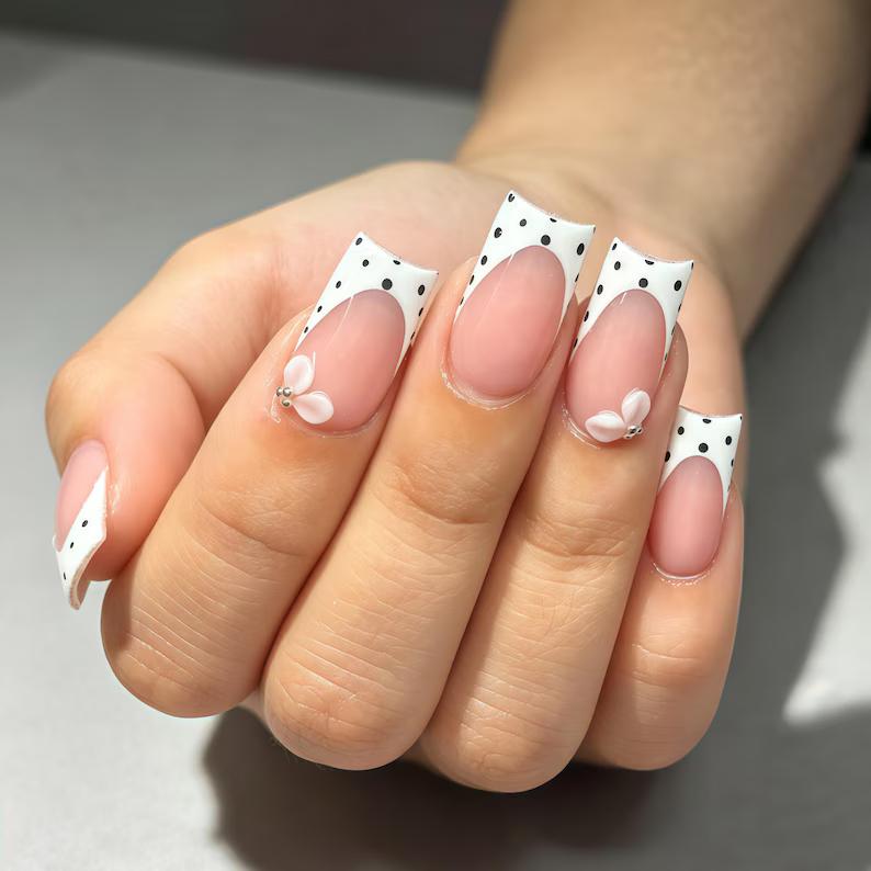 Nude Pink French Tip Nails With Black Polka Dots and 3D Bow Accents