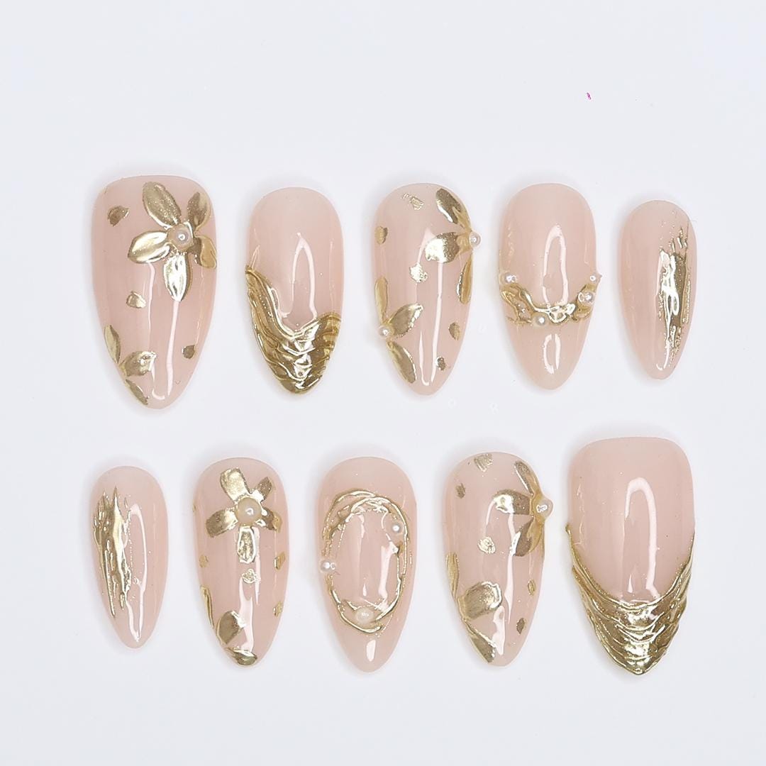 Pale Nude Pink Nails with Sculpted Gold Floral Details and Pearl Accents