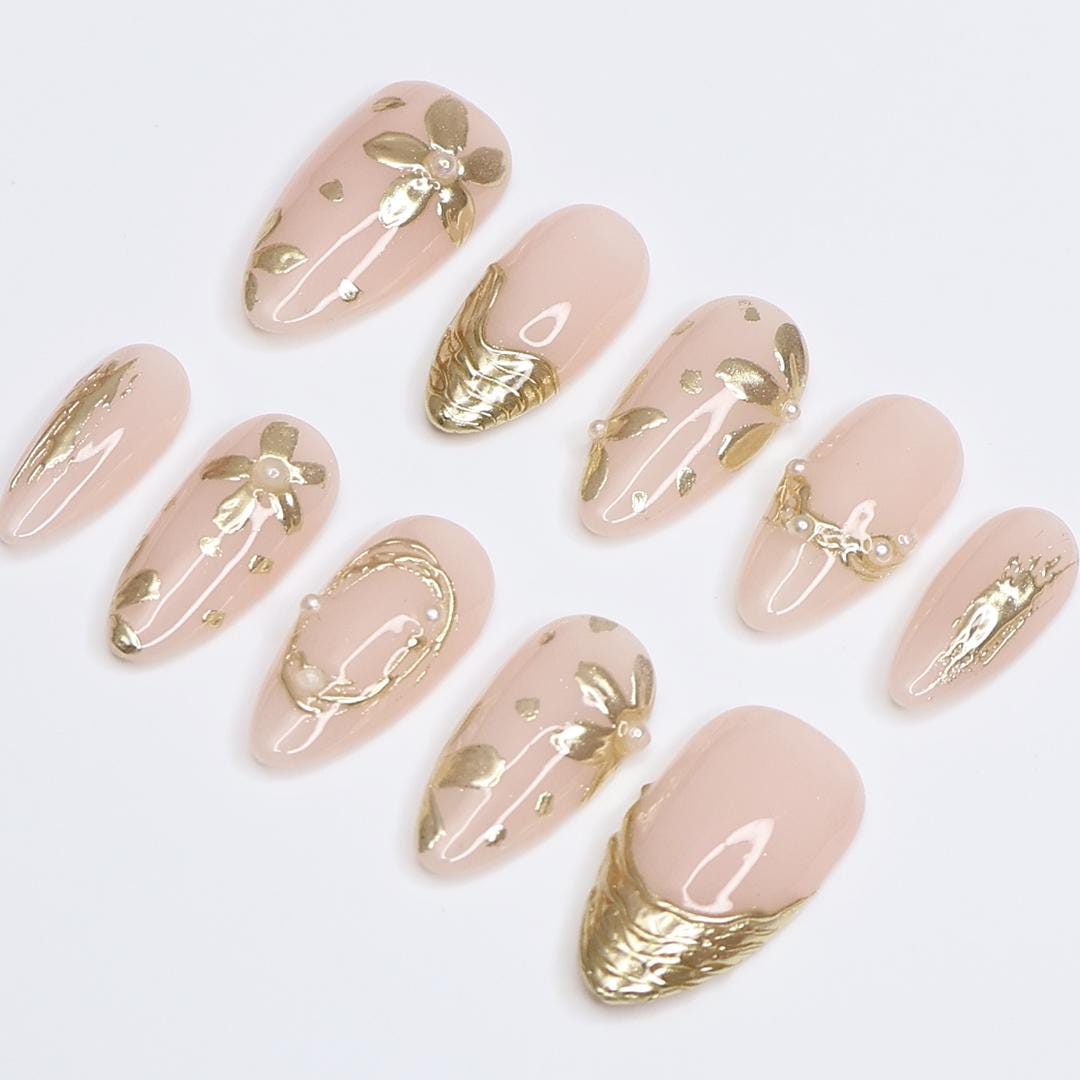 Pale Nude Pink Nails with Sculpted Gold Floral Details and Pearl Accents