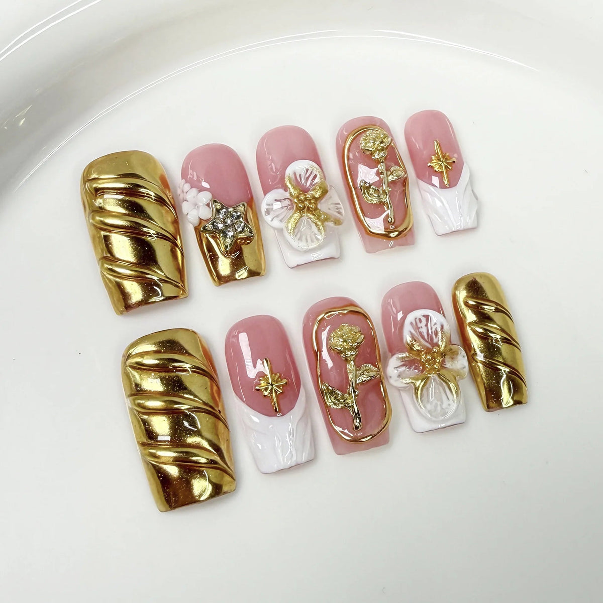 Pink and White French Tip Nails With Gold Chrome Flowers and Pearl Details