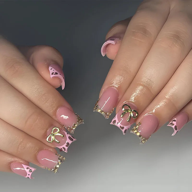 Pink Leopard French Tip Nails with Gold Bows and Beaded Accents