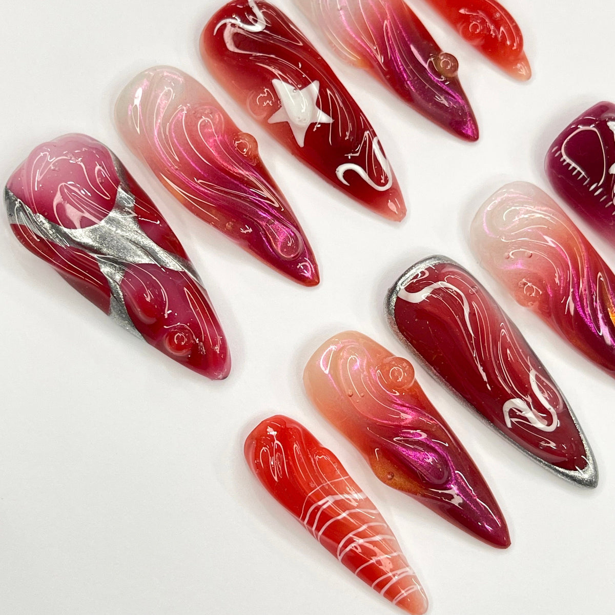 Red and Burgundy Swirl Press On Nails With White Star Charms and Silver Accents