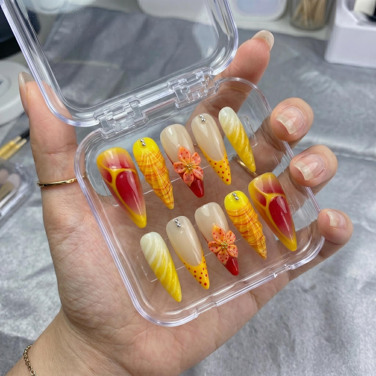 Red and Yellow Summer Tropical Flower Press-On Nails with Plaid, Marble, and Rhinestone Details