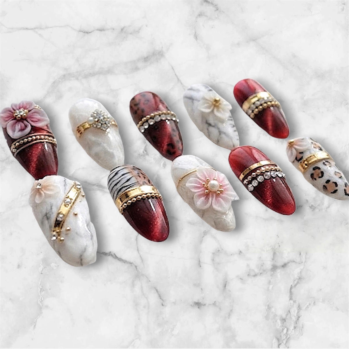 Red Cat-Eye Marble and Animal-Print Nails With 3D Flowers and Gold Details