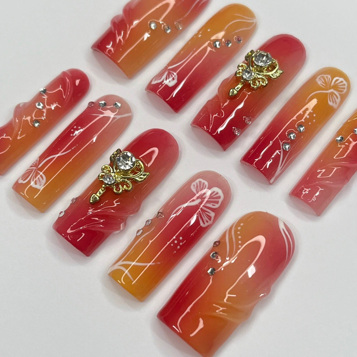 Red, Coral and Orange Gradient Nail Set with White Line Art and Crystal Charms