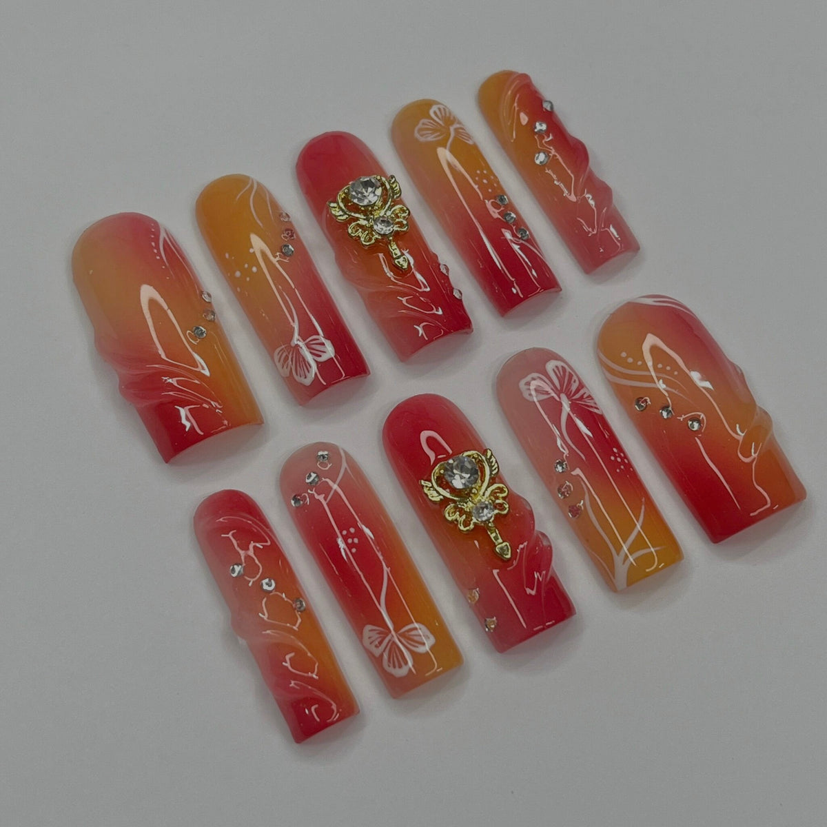 Red, Coral and Orange Gradient Nail Set with White Line Art and Crystal Charms