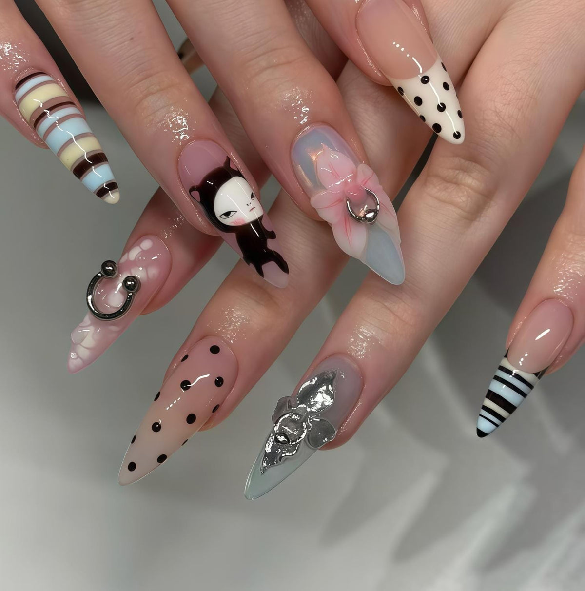 Retro Cat Nail Set With Polka Dots, Stripes, Pink Bow, and Metallic Charms