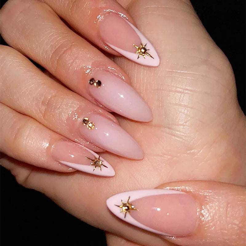 Sheer Nude Pink French Tip Nails with Gold Starburst Accents