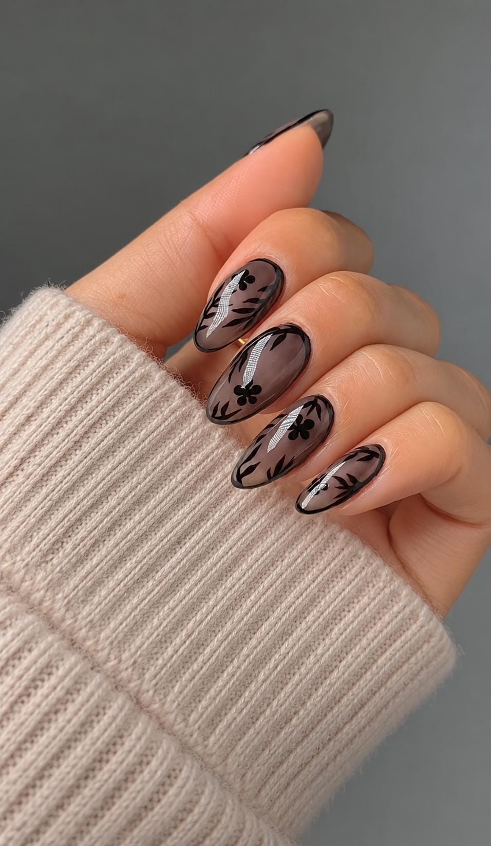 Sheer Nude Pink Nails With Black Floral and Leaf Designs