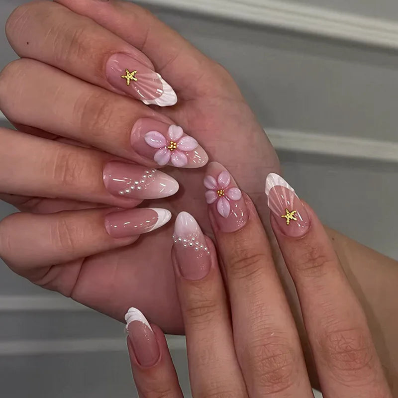 Sheer Pink French Tip Nails With 3D Flowers, Pearls and Gold Star Charms