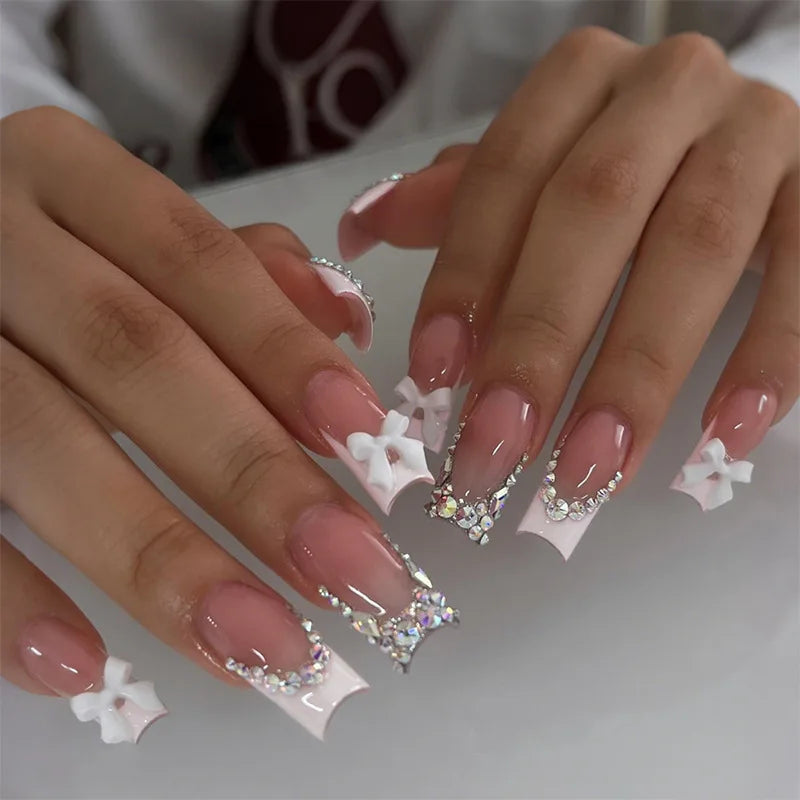 Sheer Pink French Tip Nails With 3D White Bows and Rhinestone Clusters
