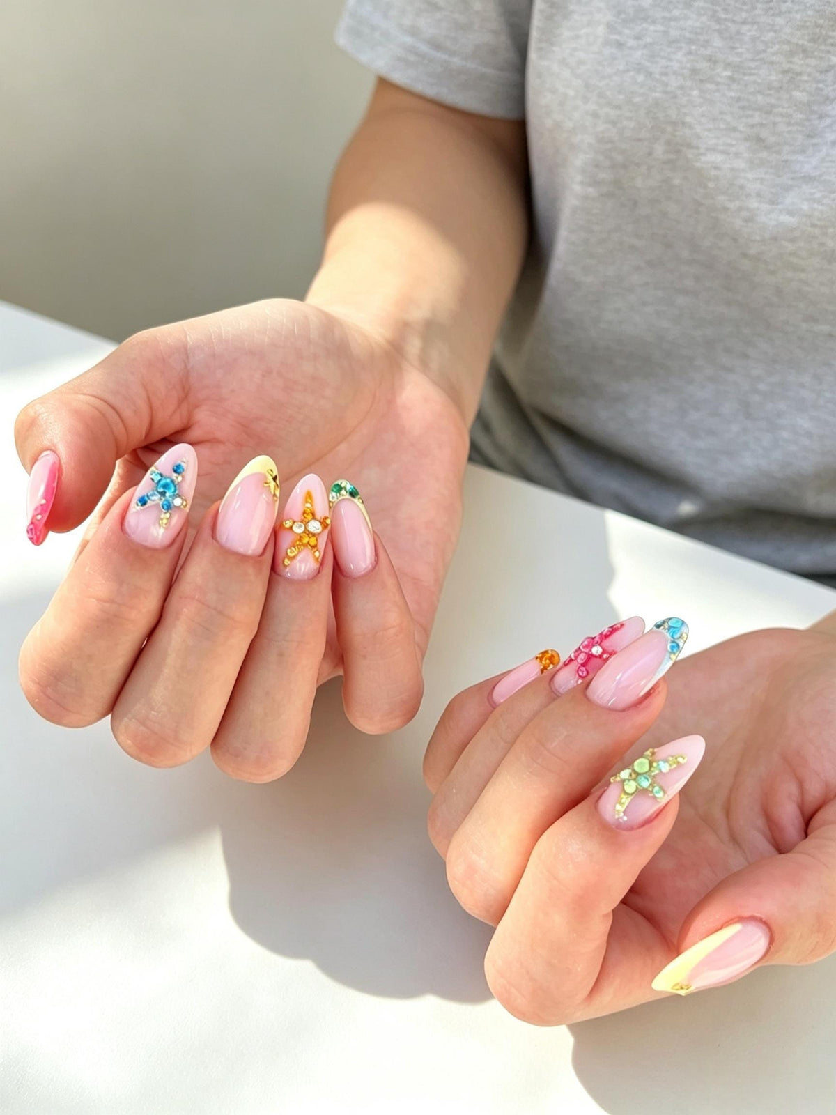 Sheer Pink French Tip Nails with Colorful 3D Starfish Rhinestones