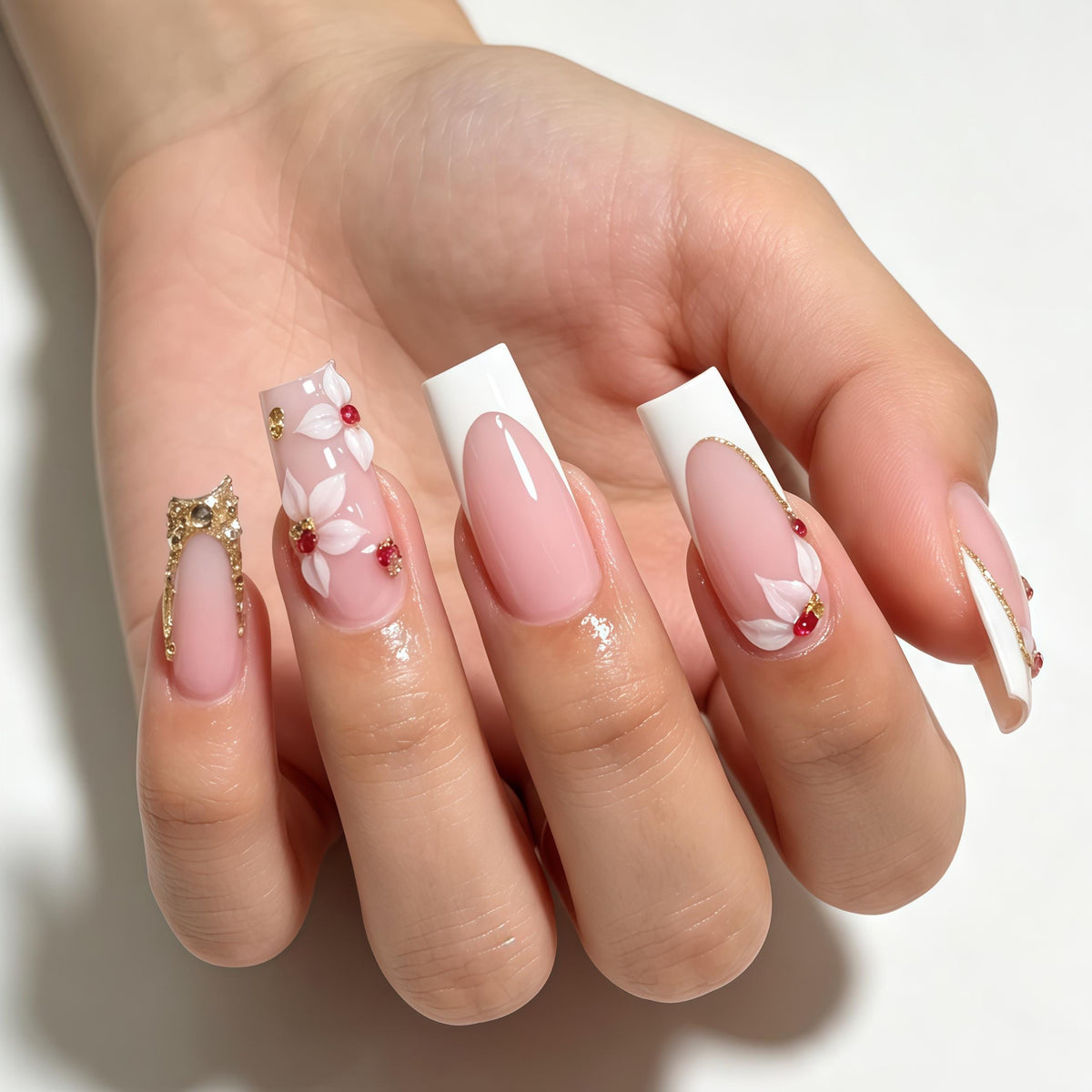 Sheer Pink French Tip Nails With White Flowers, Red Gems and Gold Accents