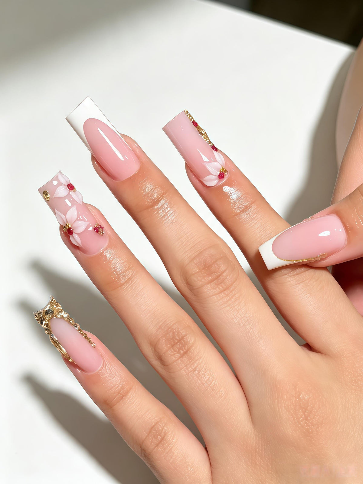 Sheer Pink French Tip Nails With White Flowers, Red Gems and Gold Accents