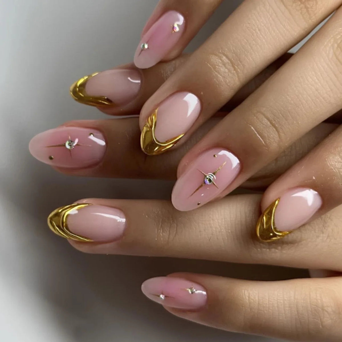Sheer Pink Nails with Gold Chrome French Tips and Curved Accents