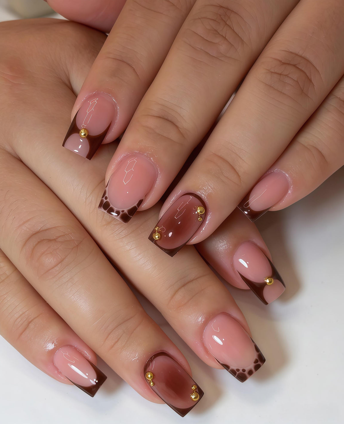 Sheer Pink Nude Nails With Brown French Tips and Gold Bead Details