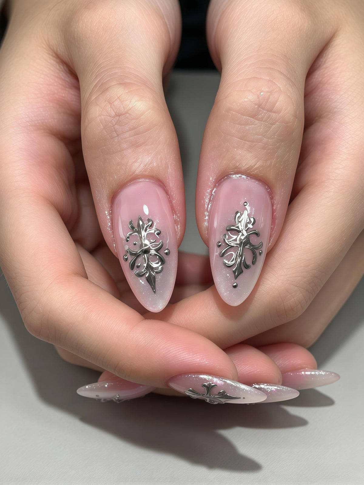 Sheer Pink Shimmer Nails With Silver Gothic Sword Designs