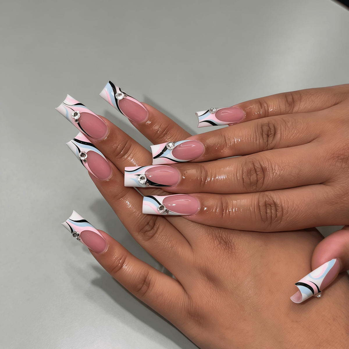 Sheer Pink Swirl Nails With White, Pale Blue, Black Lines and Rhinestones