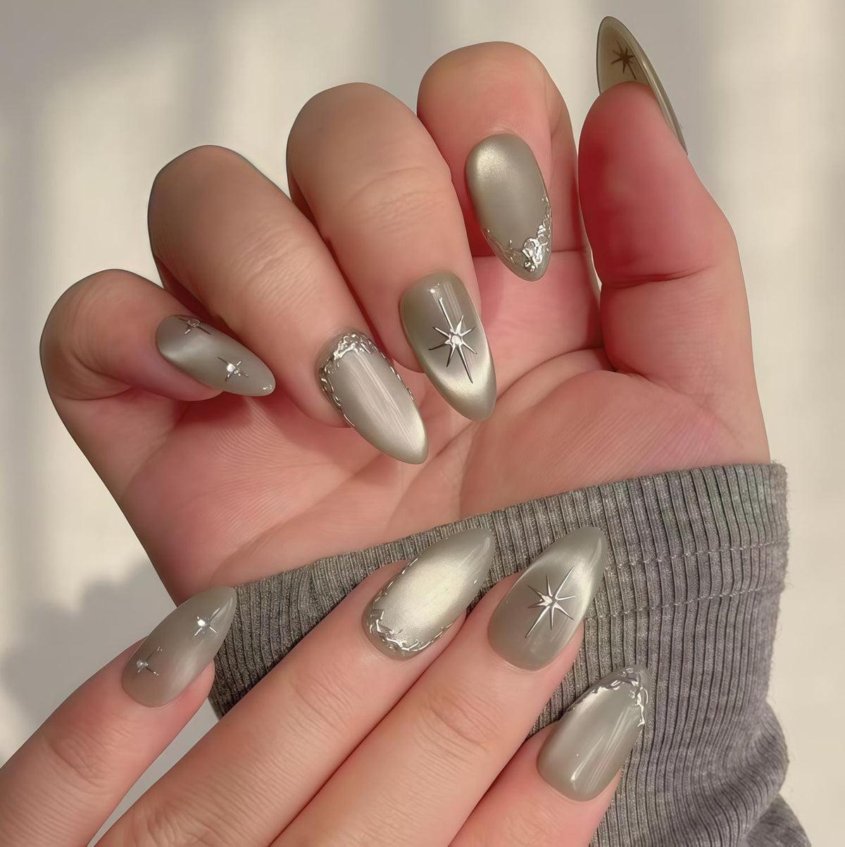 Silver Gray Cat Eye Nails With Starbursts and Raised Metallic Trim