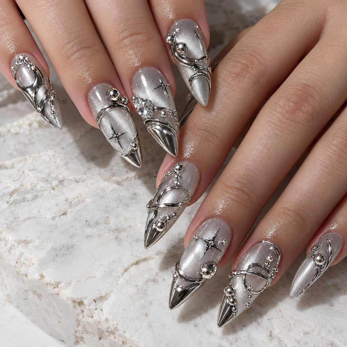 Silver Y2K Cat-Eye Chrome Nails With Raised Swirls and Rhinestone-Like Accents