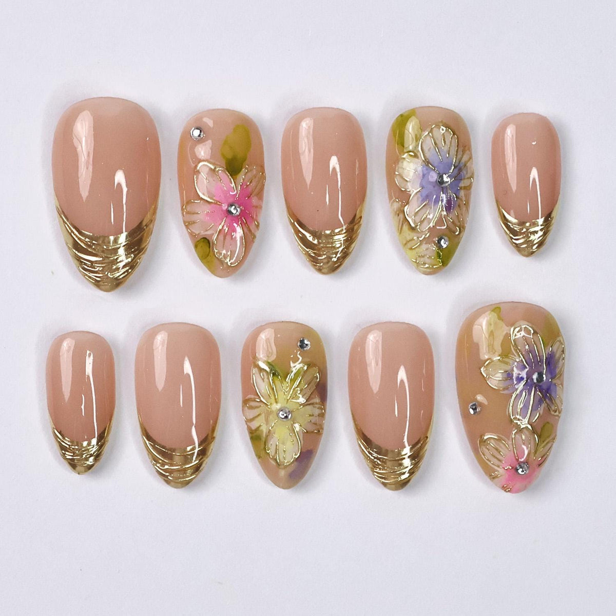 Spring Floral Nails With Nude Pink Base, Gold French Tips, and Rhinestone Accents