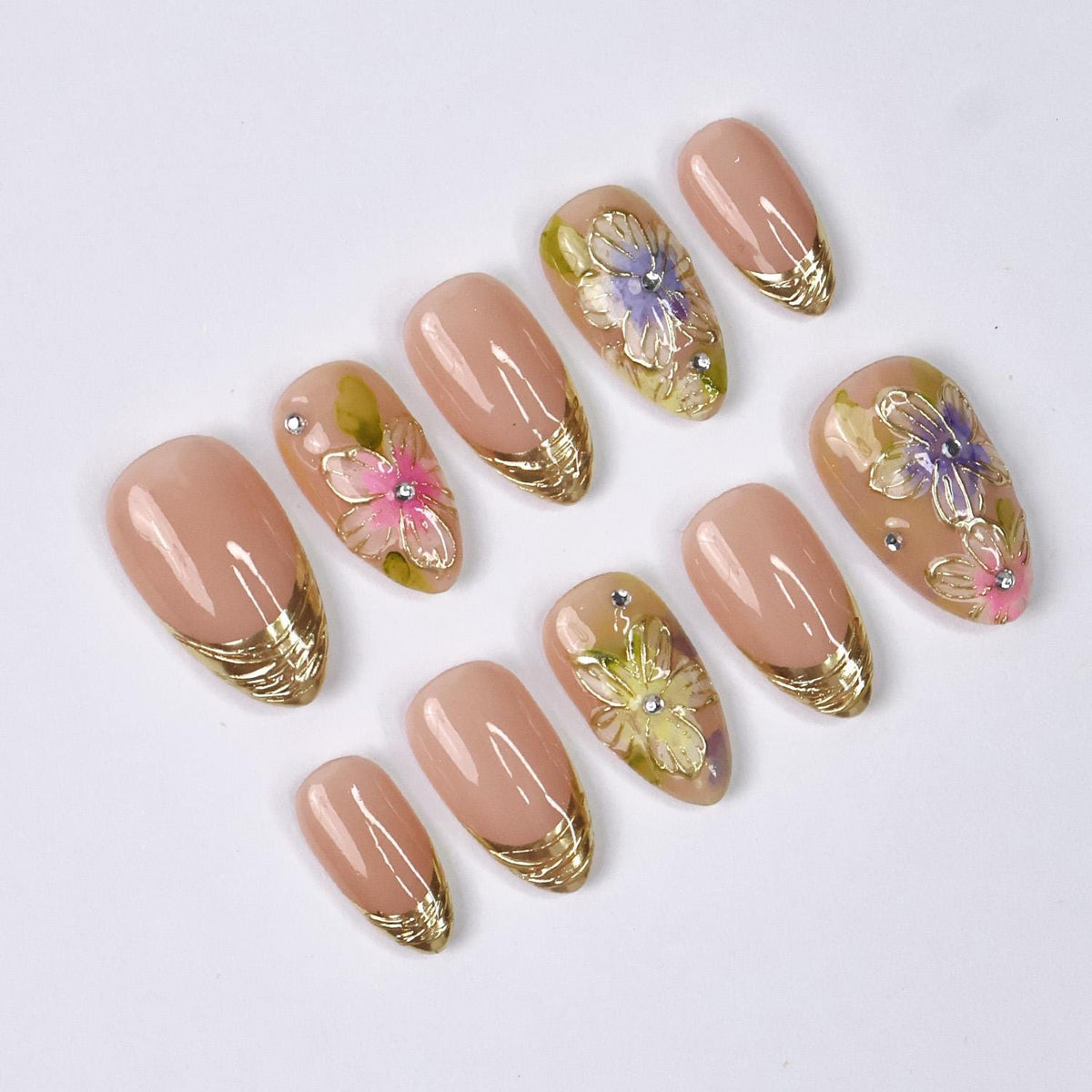 Spring Floral Nails With Nude Pink Base, Gold French Tips, and Rhinestone Accents