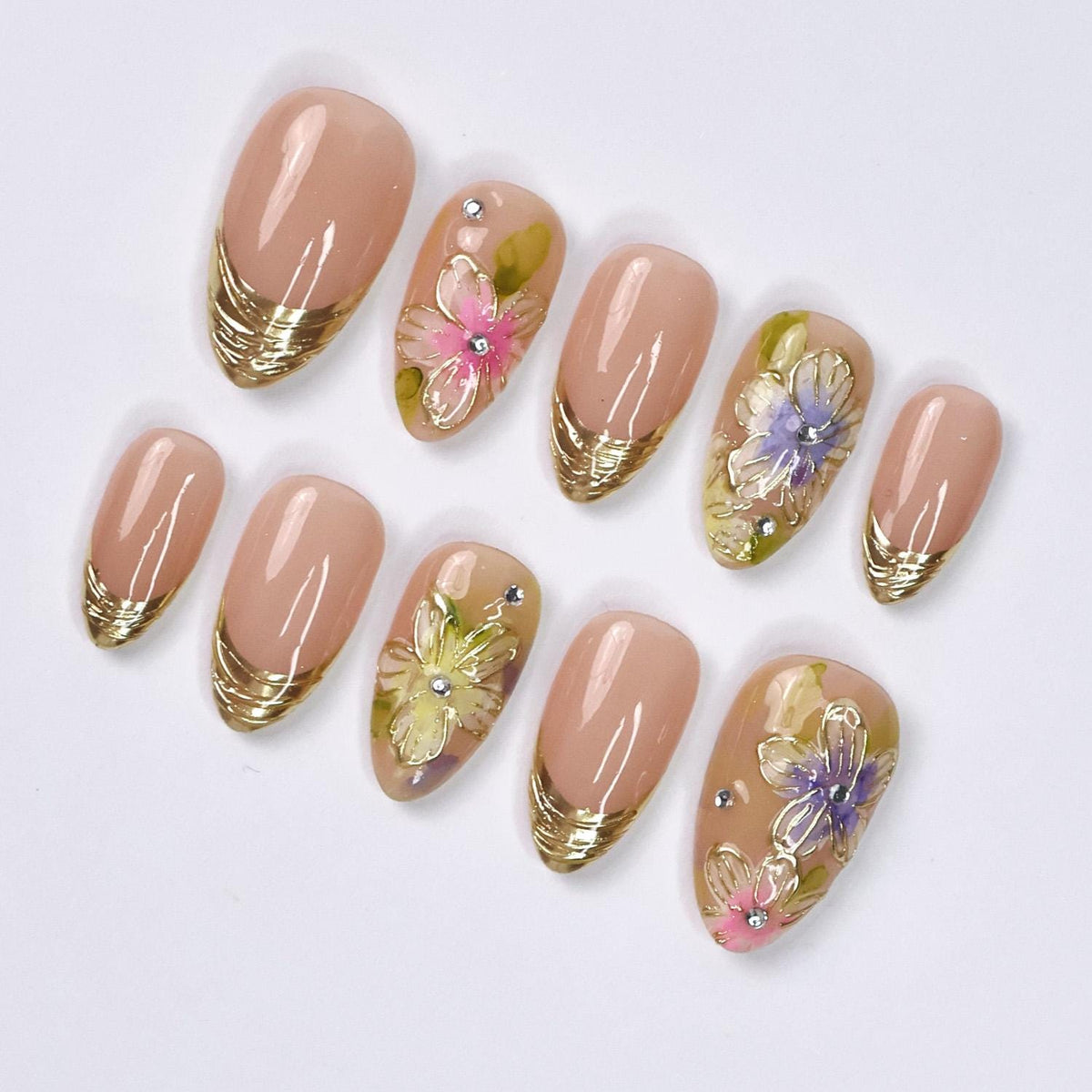 Spring Floral Nails With Nude Pink Base, Gold French Tips, and Rhinestone Accents