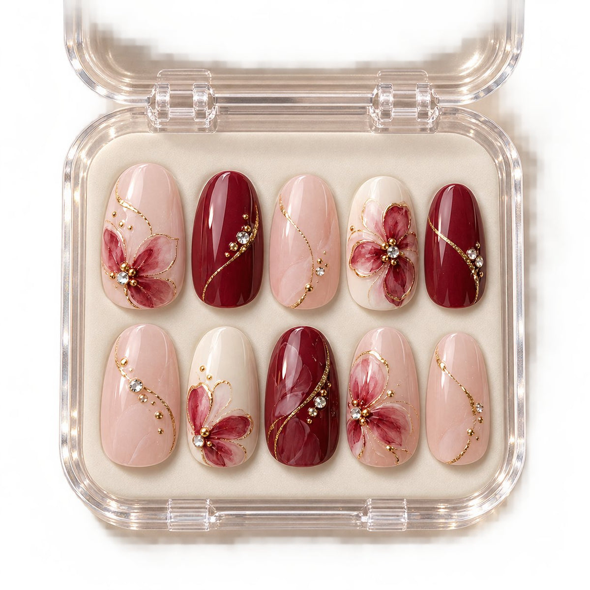 Sugarplum Floral Press On Nails with Cranberry, Blush Pink, Gold Arcs and Crystal Accents in clear acrylic storage box