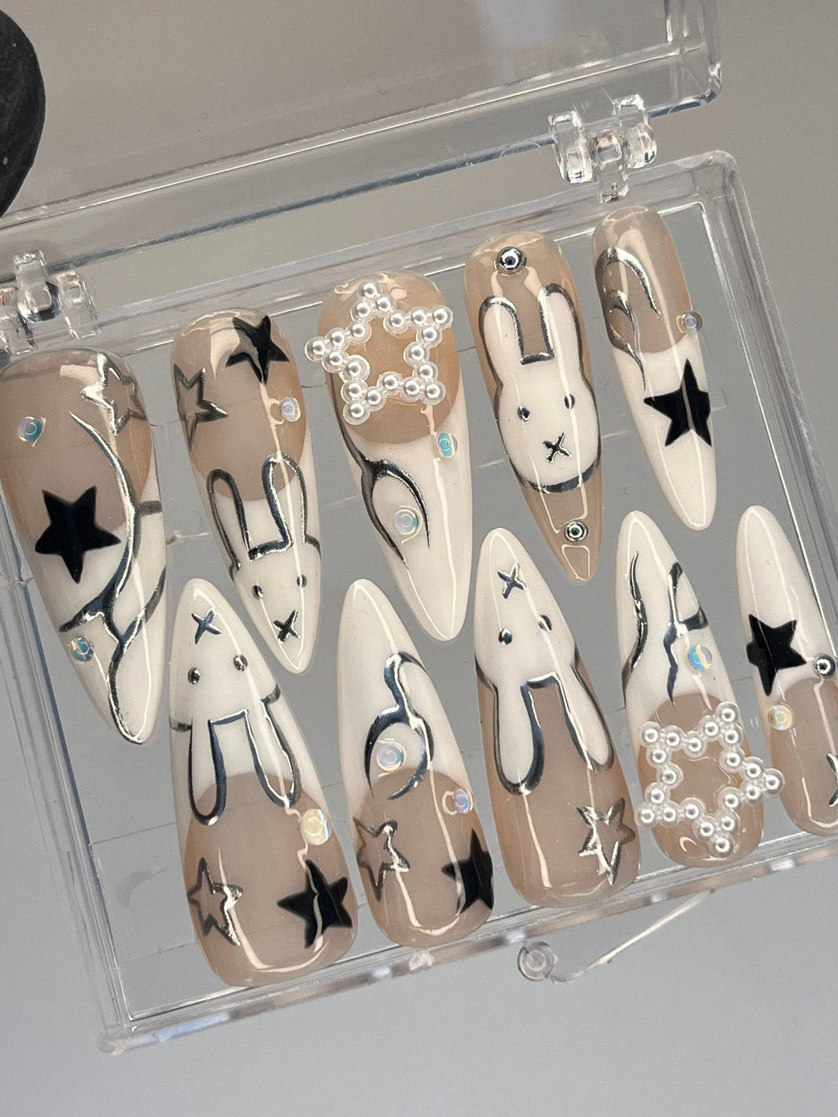 Taupe and White Star & Rabbit Nails With Pearl Clusters