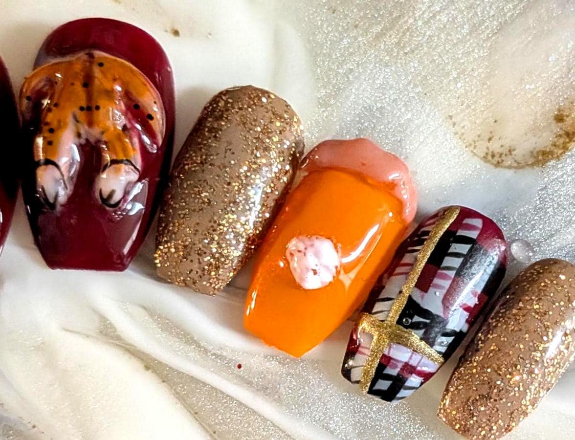 Thanksgiving Turkey Nails With Burgundy Plaid, Orange Pie Details, and Gold Glitter