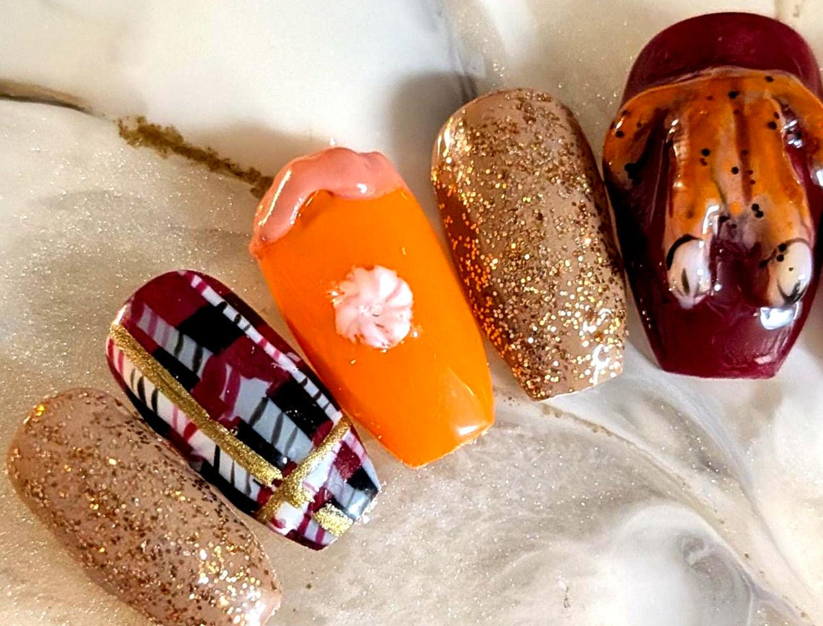 Thanksgiving Turkey Nails With Burgundy Plaid, Orange Pie Details, and Gold Glitter