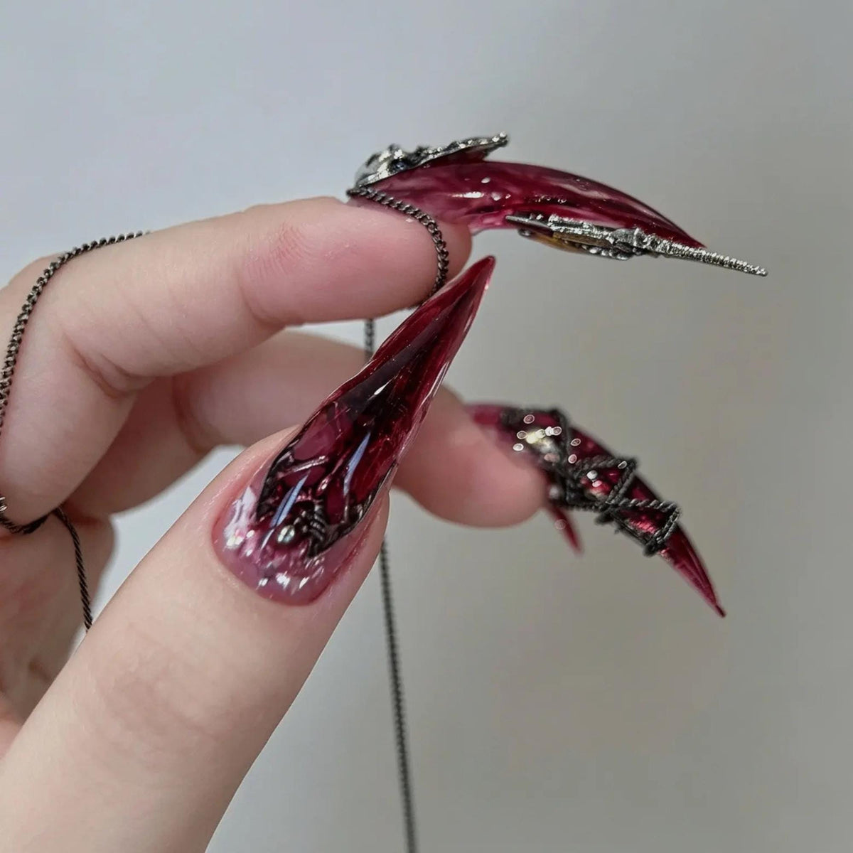 Translucent Burgundy Gothic Nails With Silver Chains and Raised Charms