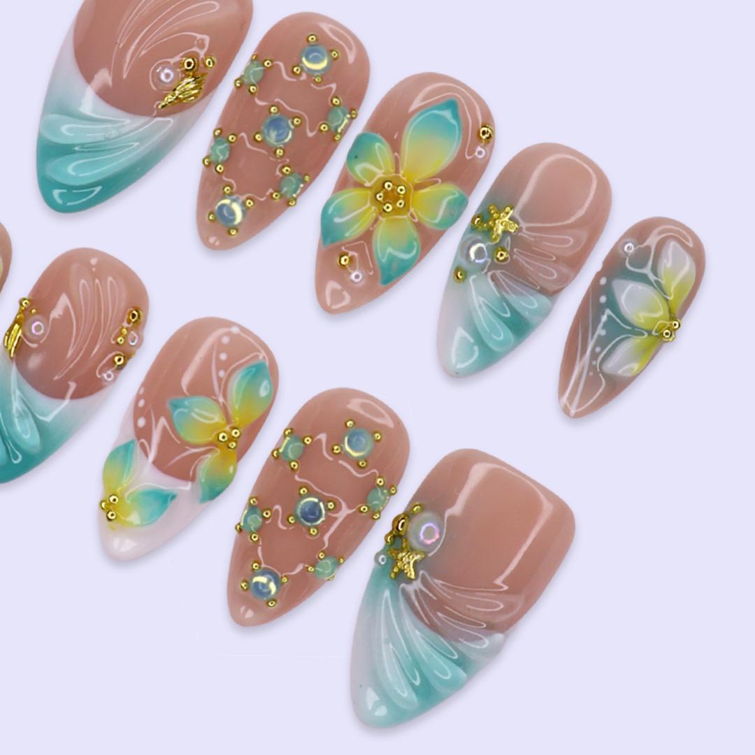 Tropical Flower and Shell Line-Art Nails with Aqua Tips and Gold-Toned Details