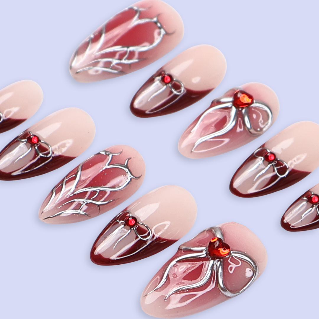 Valentine Nude Pink and Red French Tip Nails with Silver Bow and Heart Motifs