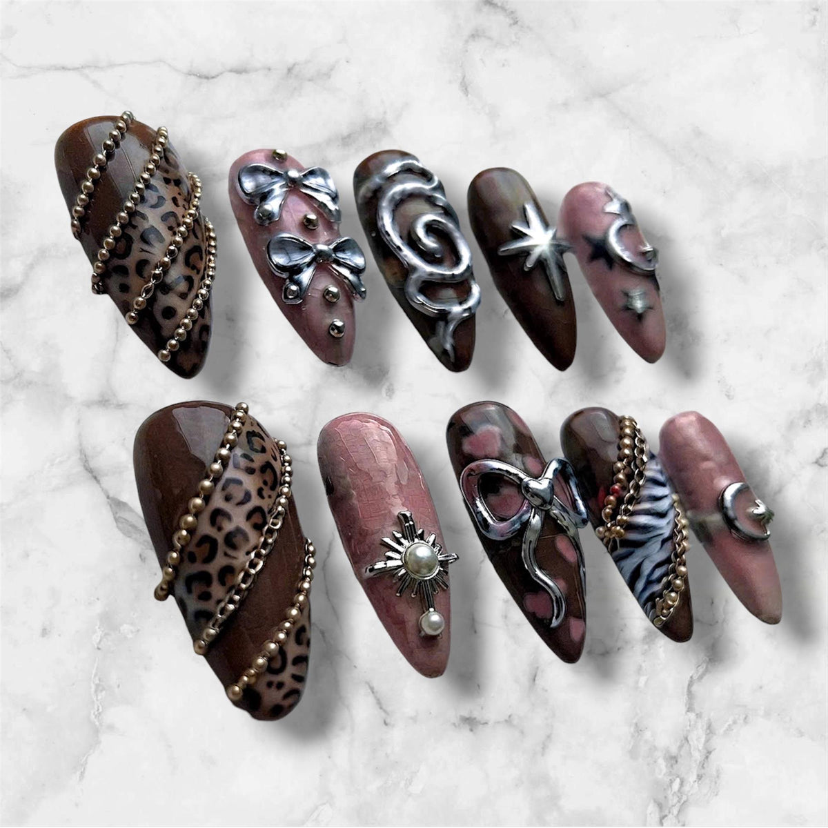 Y2K Brown and Pink Leopard Print Nails with Silver Bows and Celestial Charms