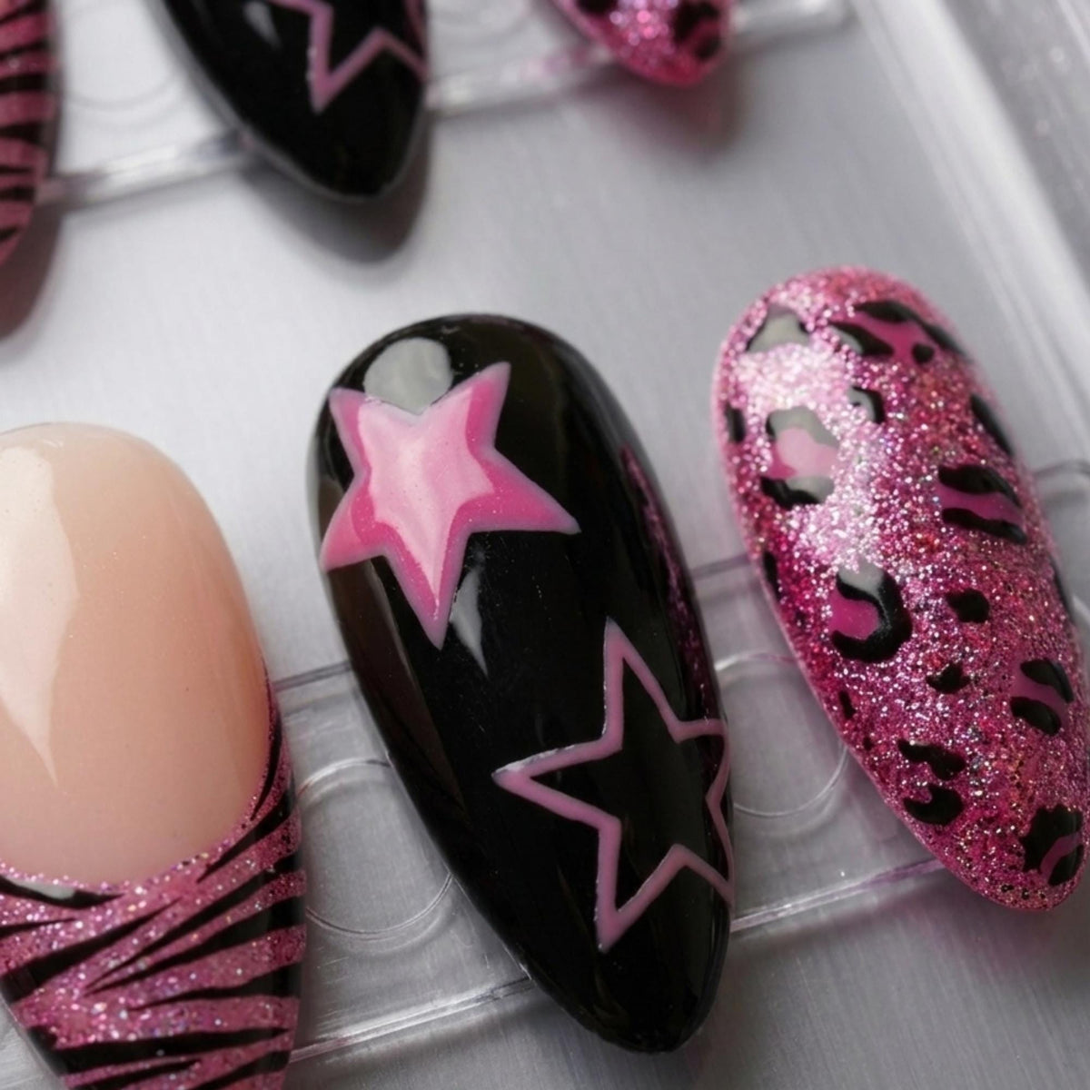 Y2K Pink and Black Star Nails With Zebra French Tips and Glitter Leopard Print