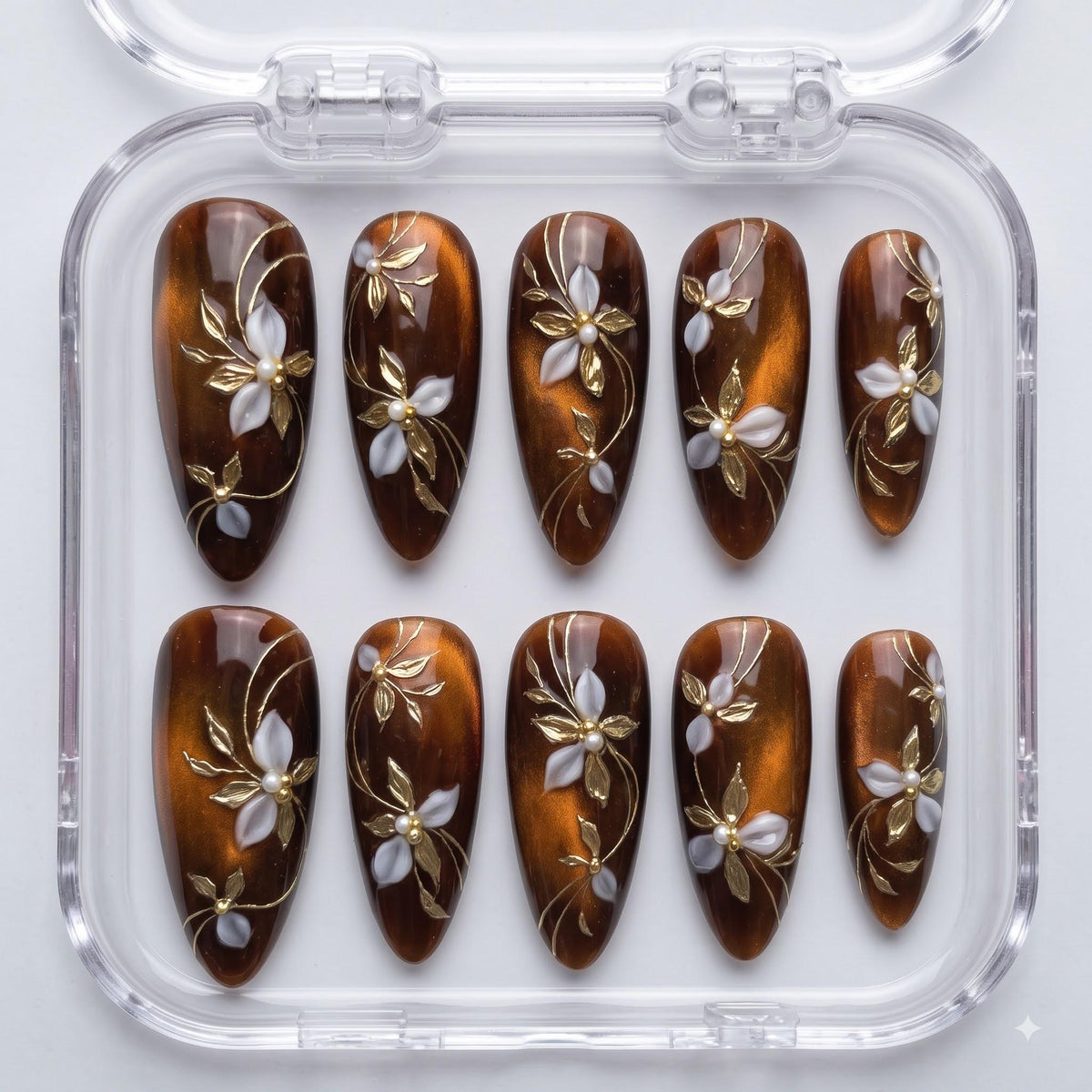 Amber and Brown Cat Eye Nails With Gold Vines and Pearl-Centered Flowers