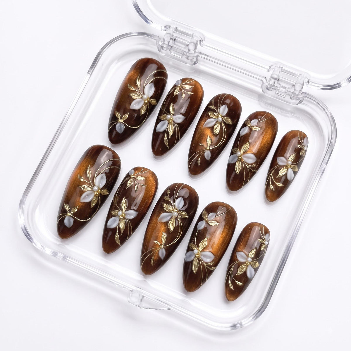 Amber and Brown Cat Eye Nails With Gold Vines and Pearl-Centered Flowers