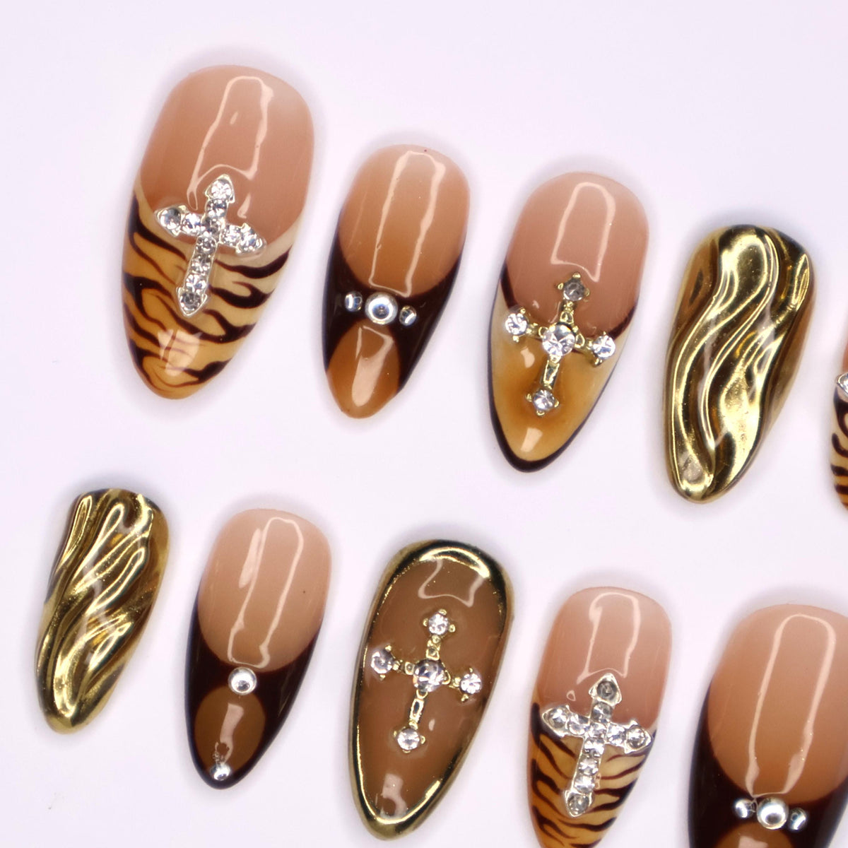 Autumn Tiger Print French Tip Nails with Rhinestone Crosses and Gold Chrome