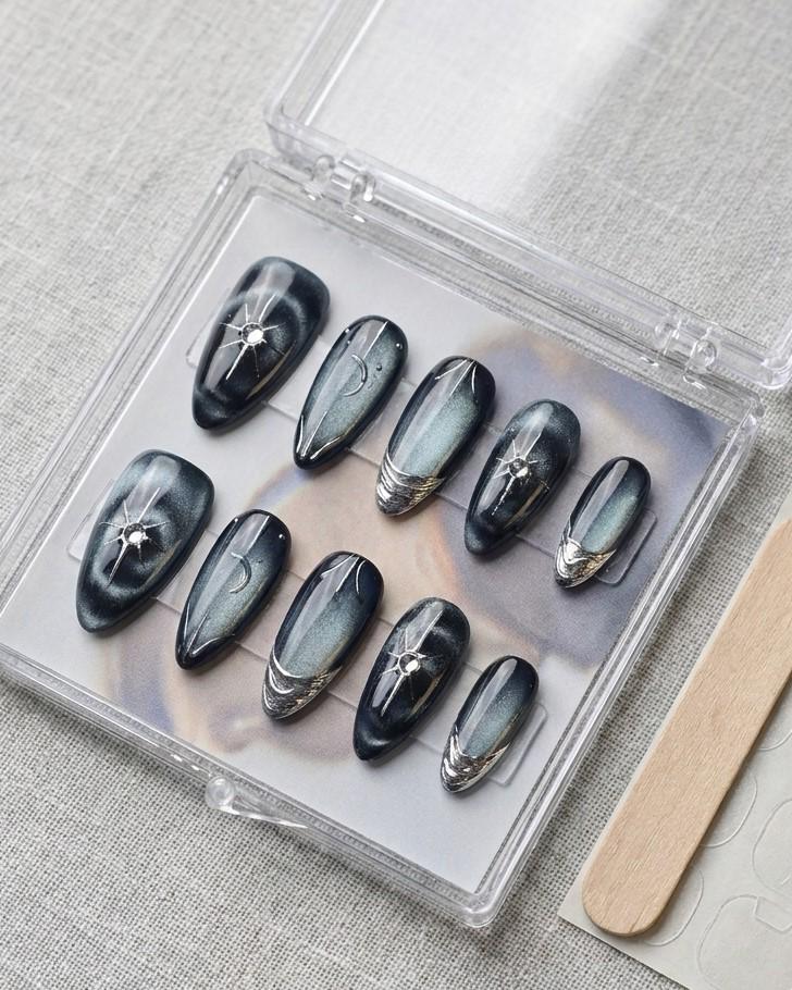 Black and Navy Cat Eye Nails with Chrome Starbursts and Metallic French Tips