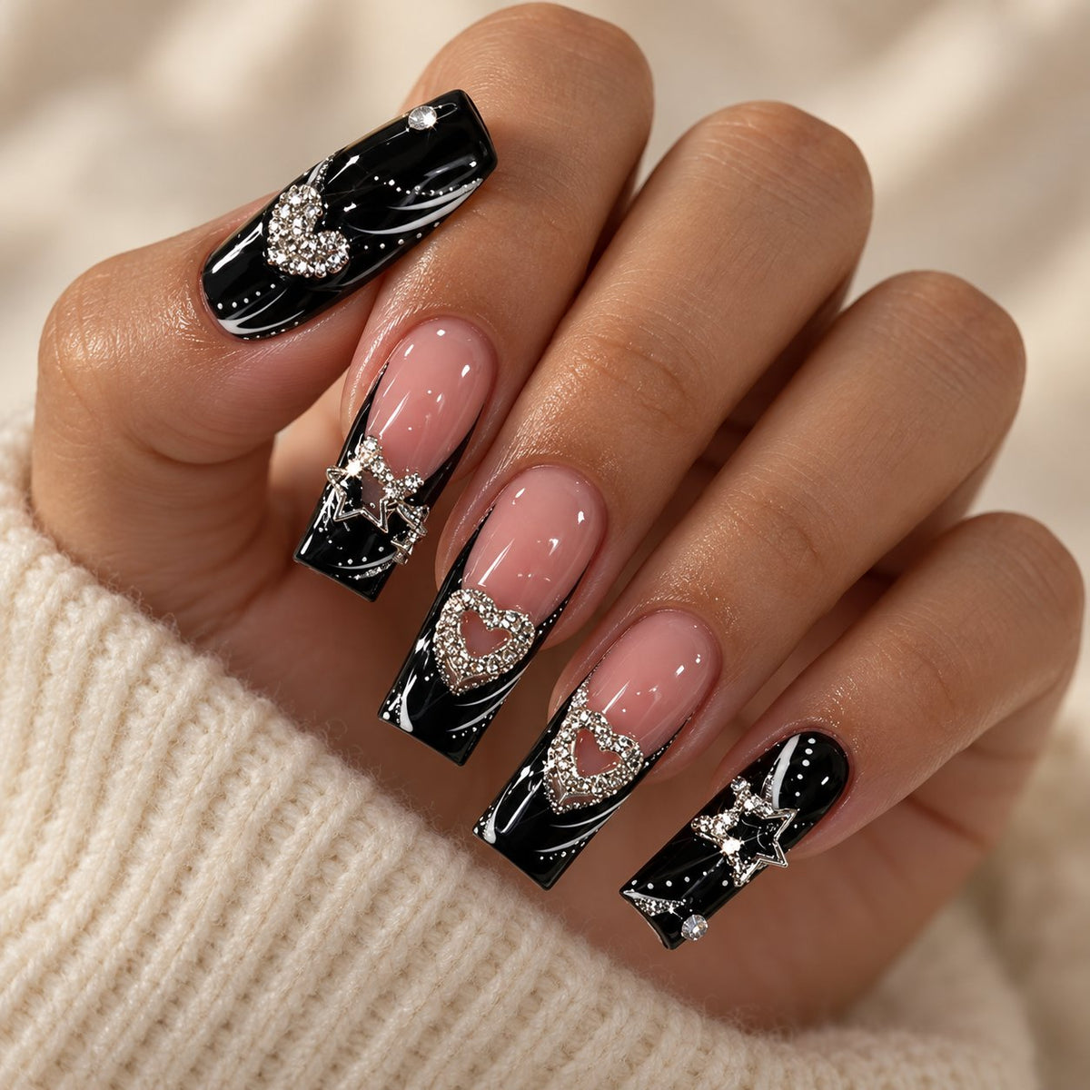 Black and Nude French Tip Press On Nails with Silver Heart Rhinestones worn on hand