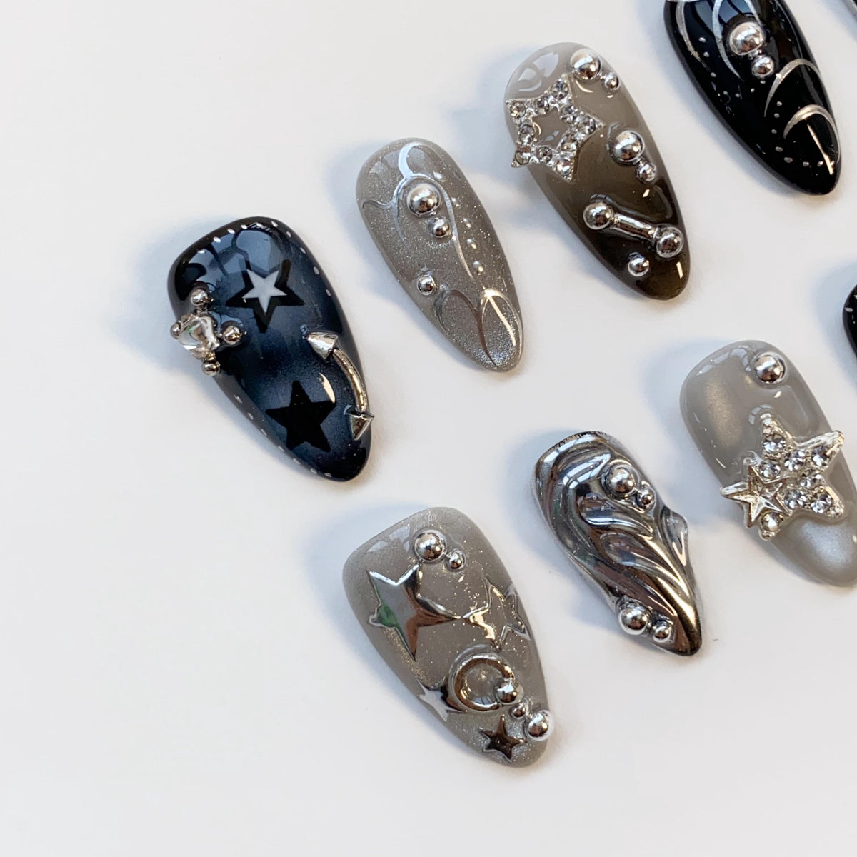 Black and Smoky Gray Star Nails with Silver Chrome Swirls