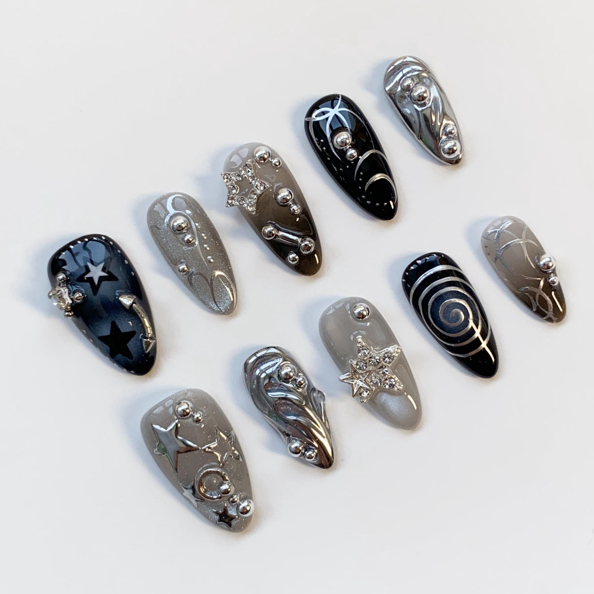 Black and Smoky Gray Star Nails with Silver Chrome Swirls