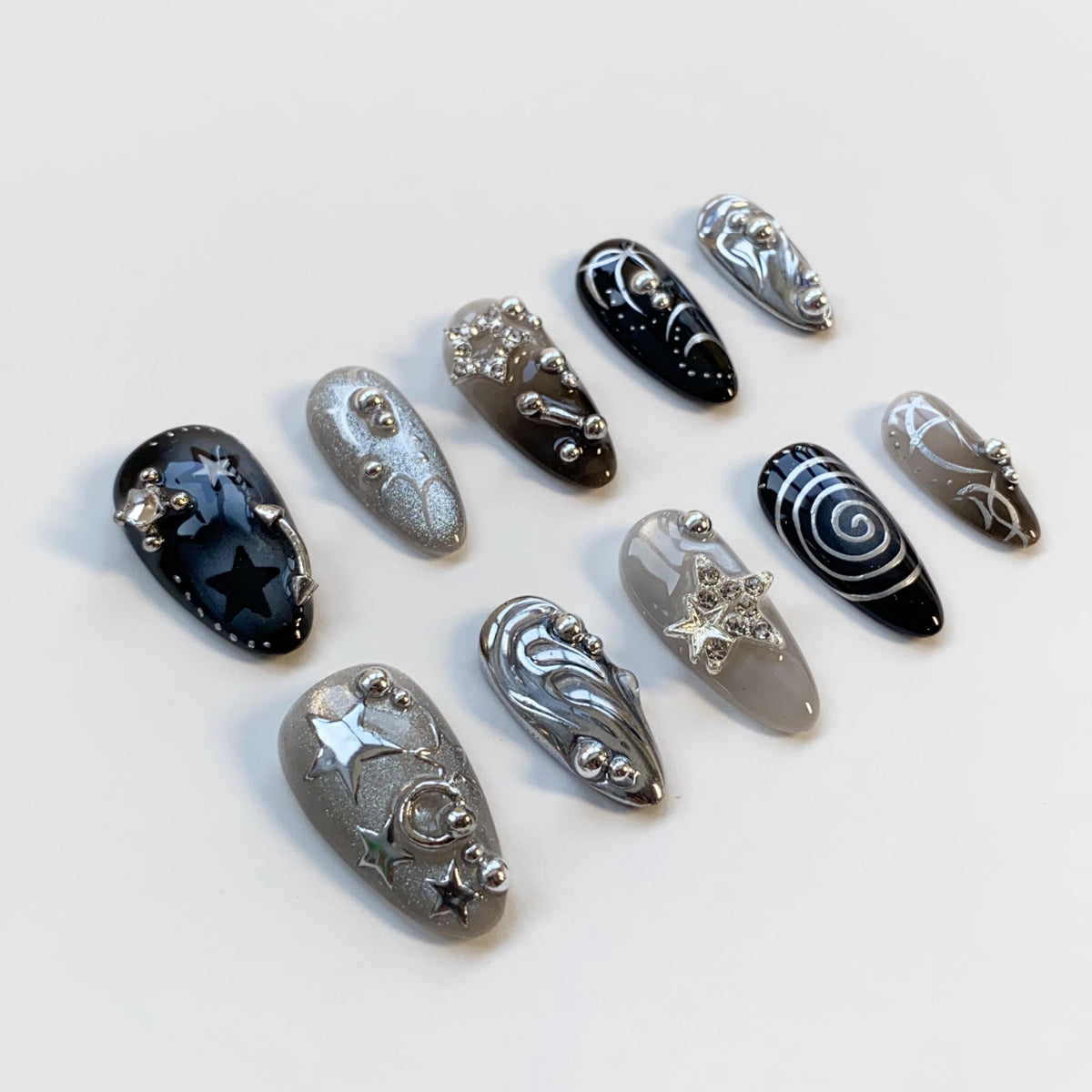Black and Smoky Gray Star Nails with Silver Chrome Swirls