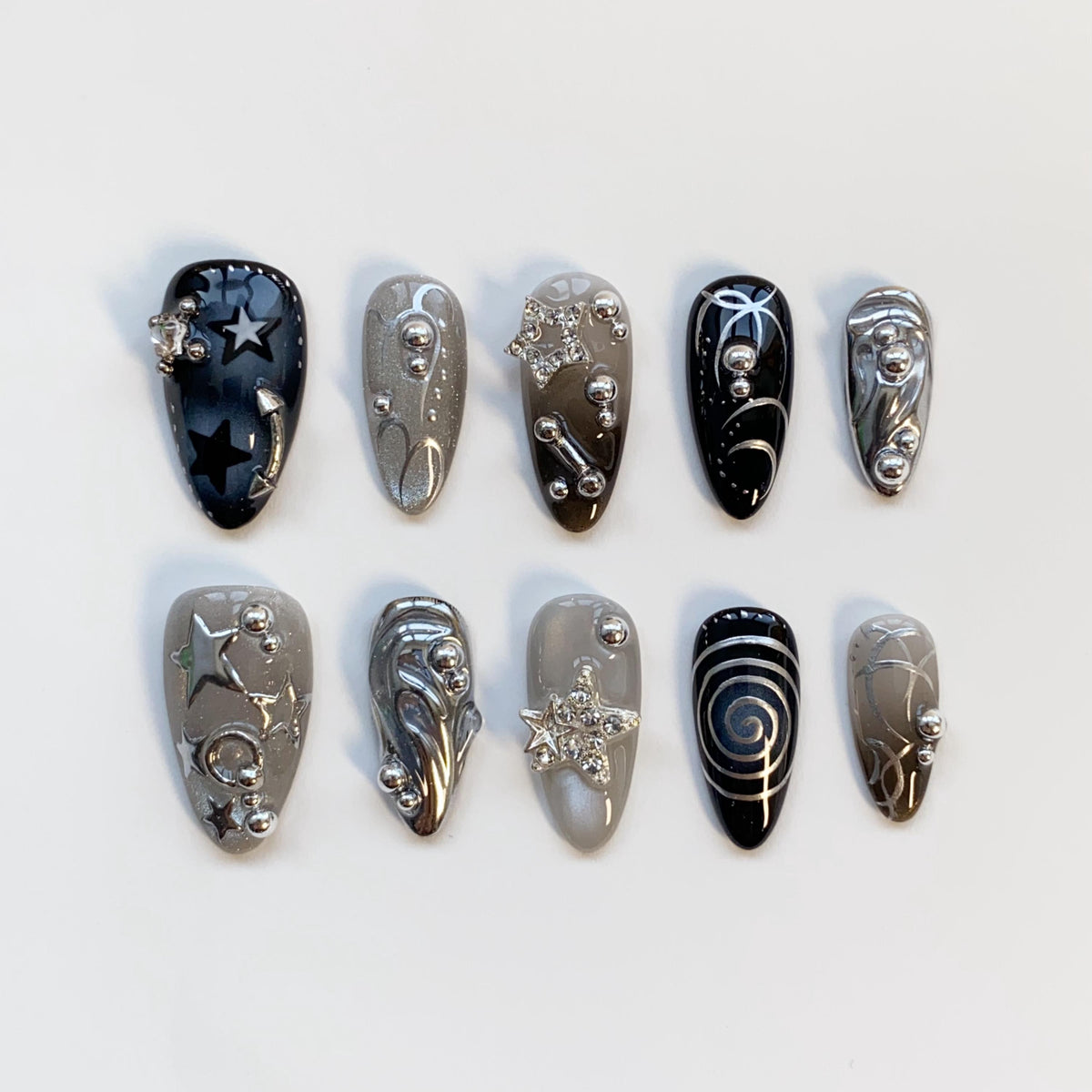 Black and Smoky Gray Star Nails with Silver Chrome Swirls